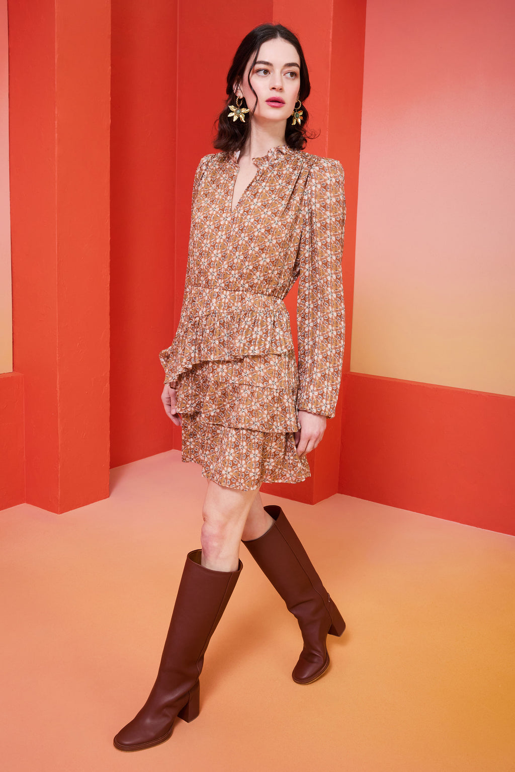 short brown patterned dress with tiered ruffles that is cinched in at the waist 