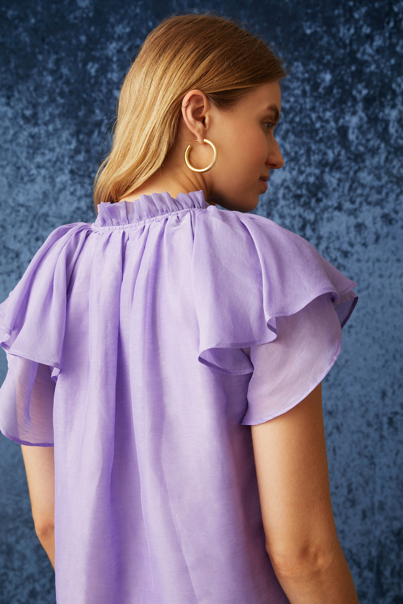 Short sleeve top with ruffled sleeves and ruffled v-neckline with a straight silhouette