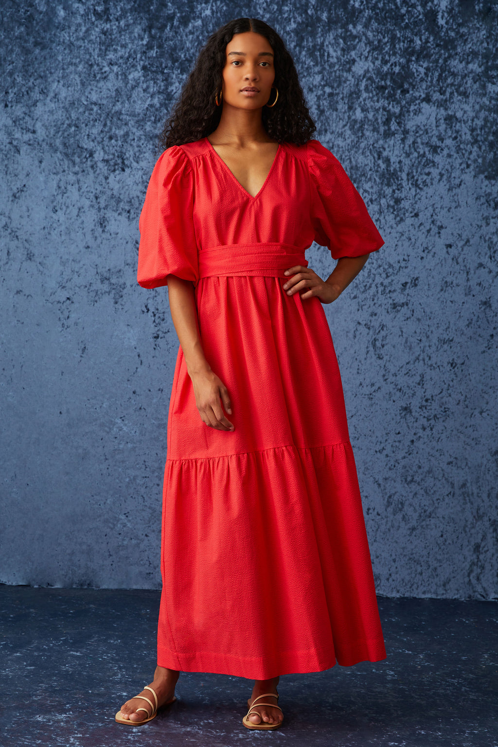 Bright red maxi dress with large puff sleeves and a v-neckline