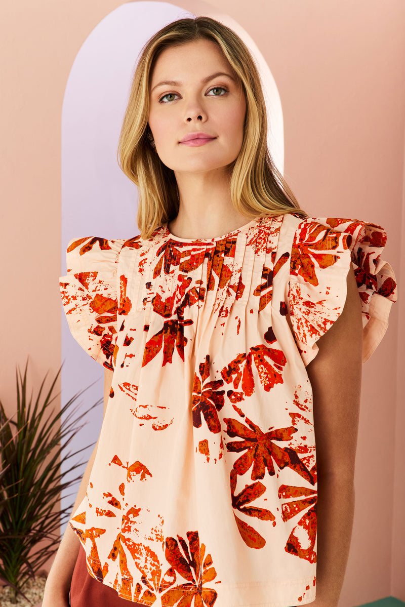 short flutter sleeve blouse with a button at the back of the neckline and clay abstract floral pattern 