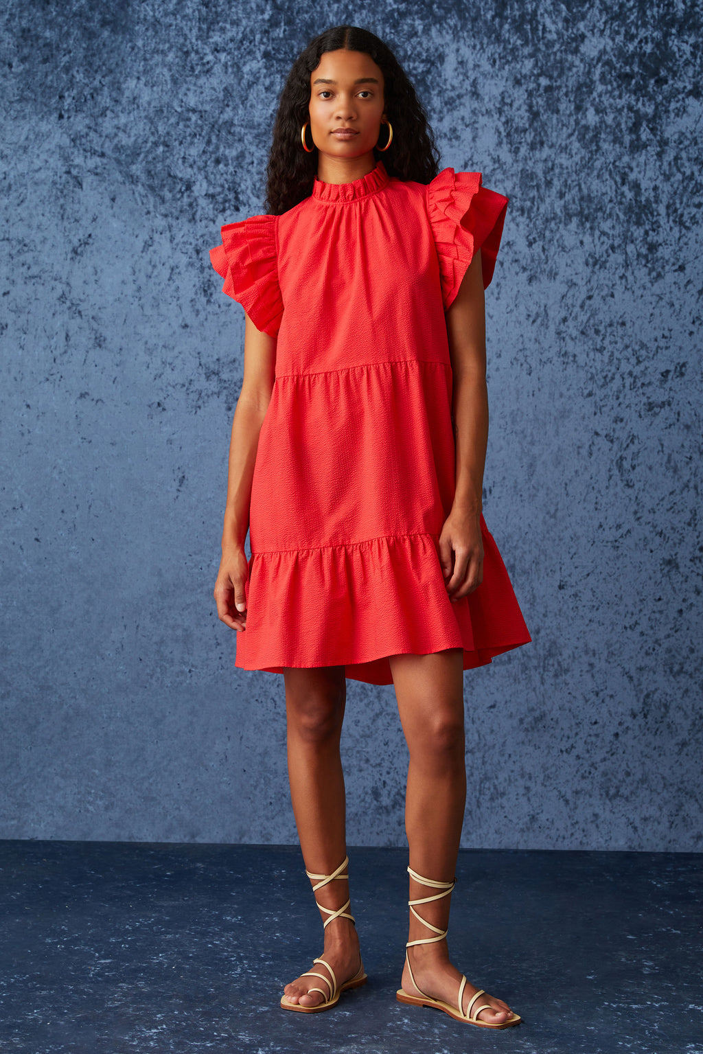Short dress with short tiered ruffle sleeves and a high ruffled neckline in a bright red
