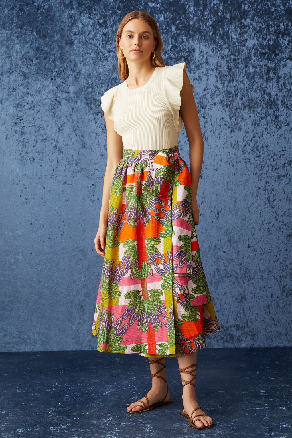 Wrap skirt with long ties that are fringed at the ends in a multicolor plaid with palm leaves