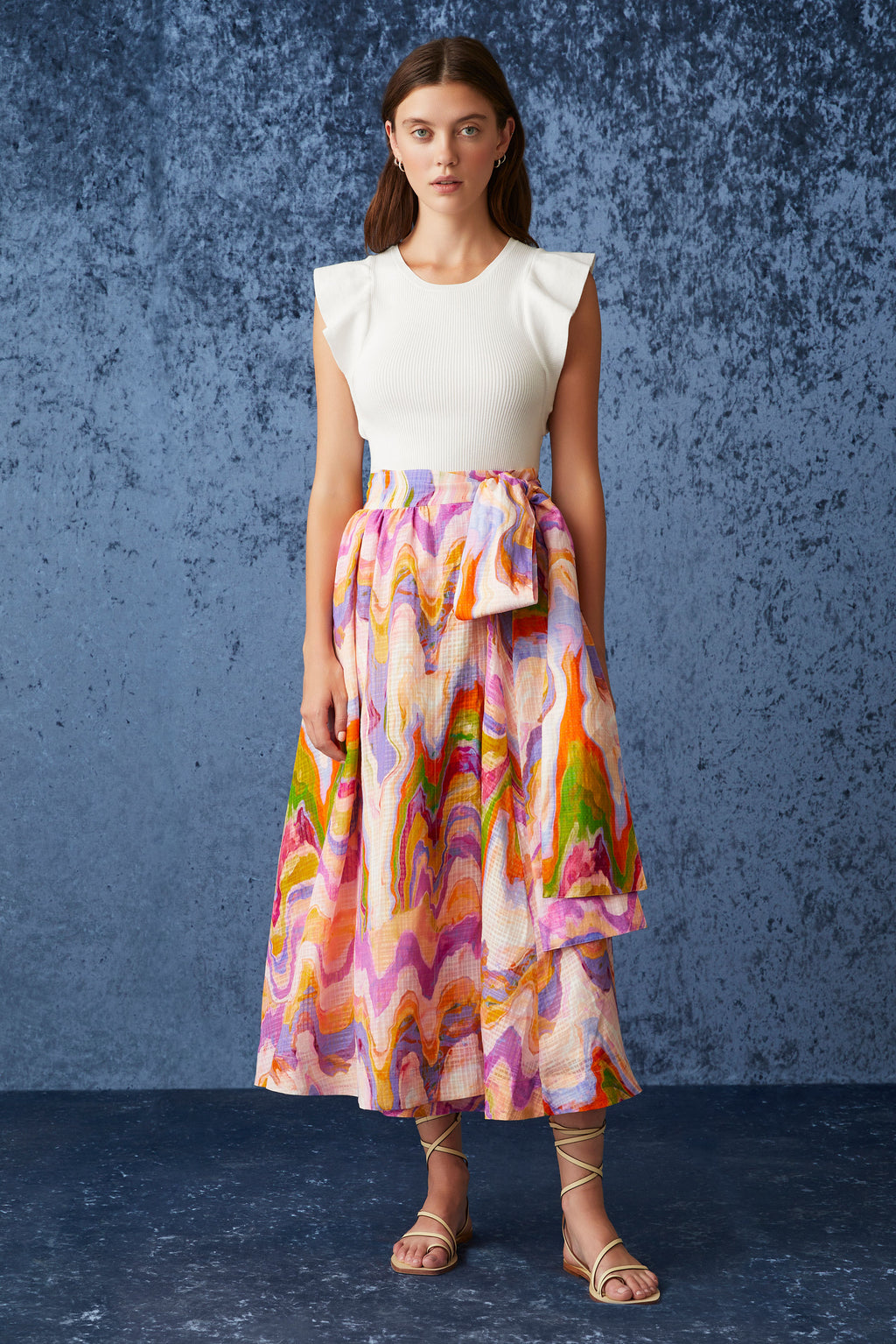 Traditional wrap skirt with long tie belt at the waist in a pink pastel marble like print 