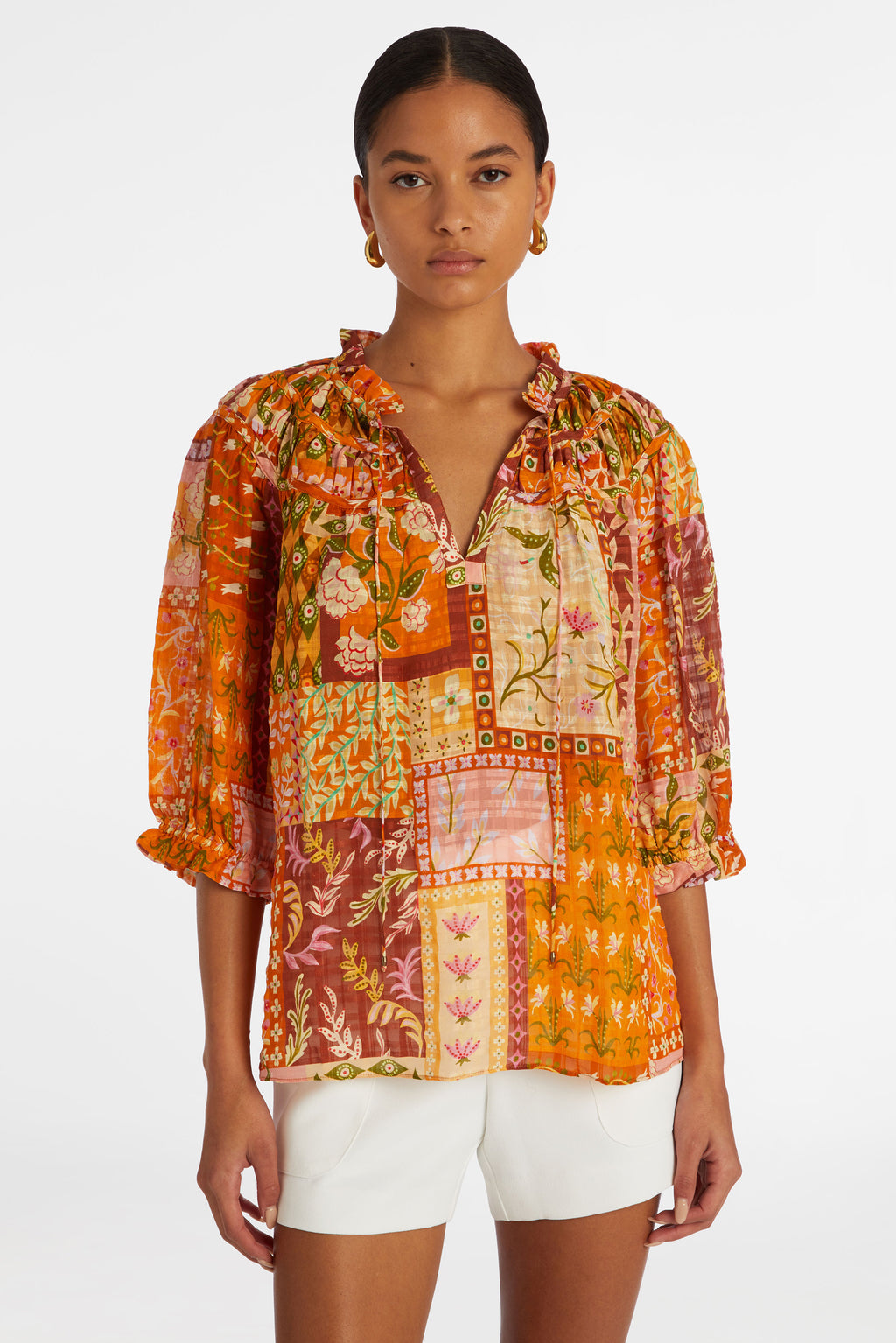 Orange floral patchwork blouse with elbow length sleeves and ruffled cuff at the end of the sleeve