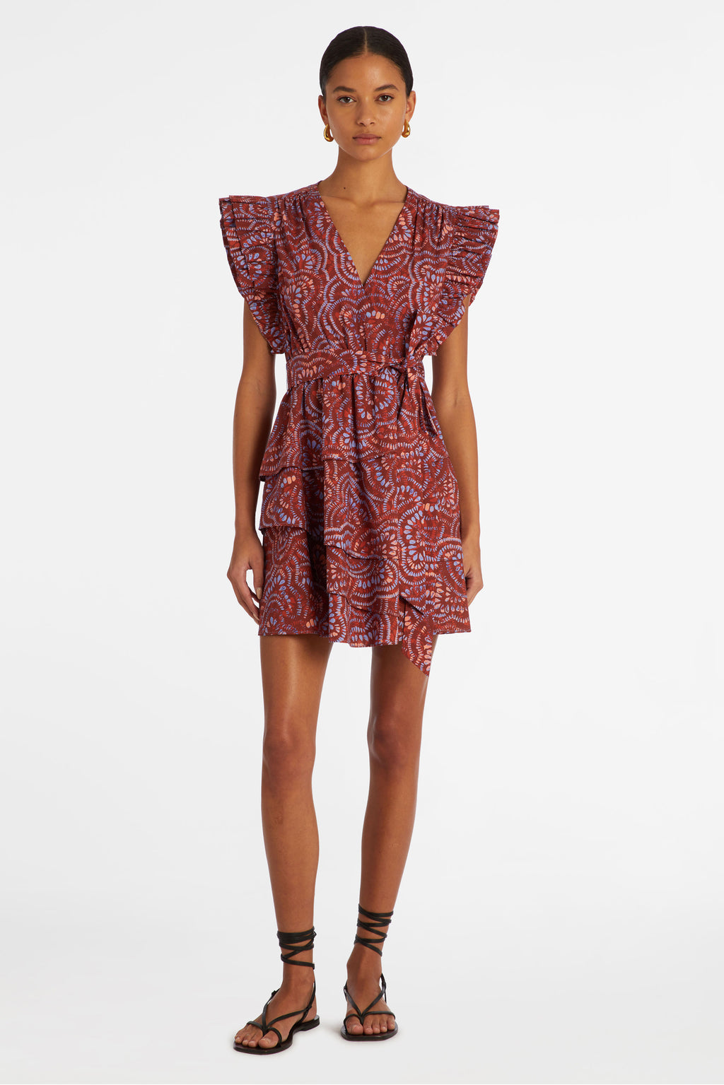 Short dress with a tiered skirt that has a sash belt at the waist