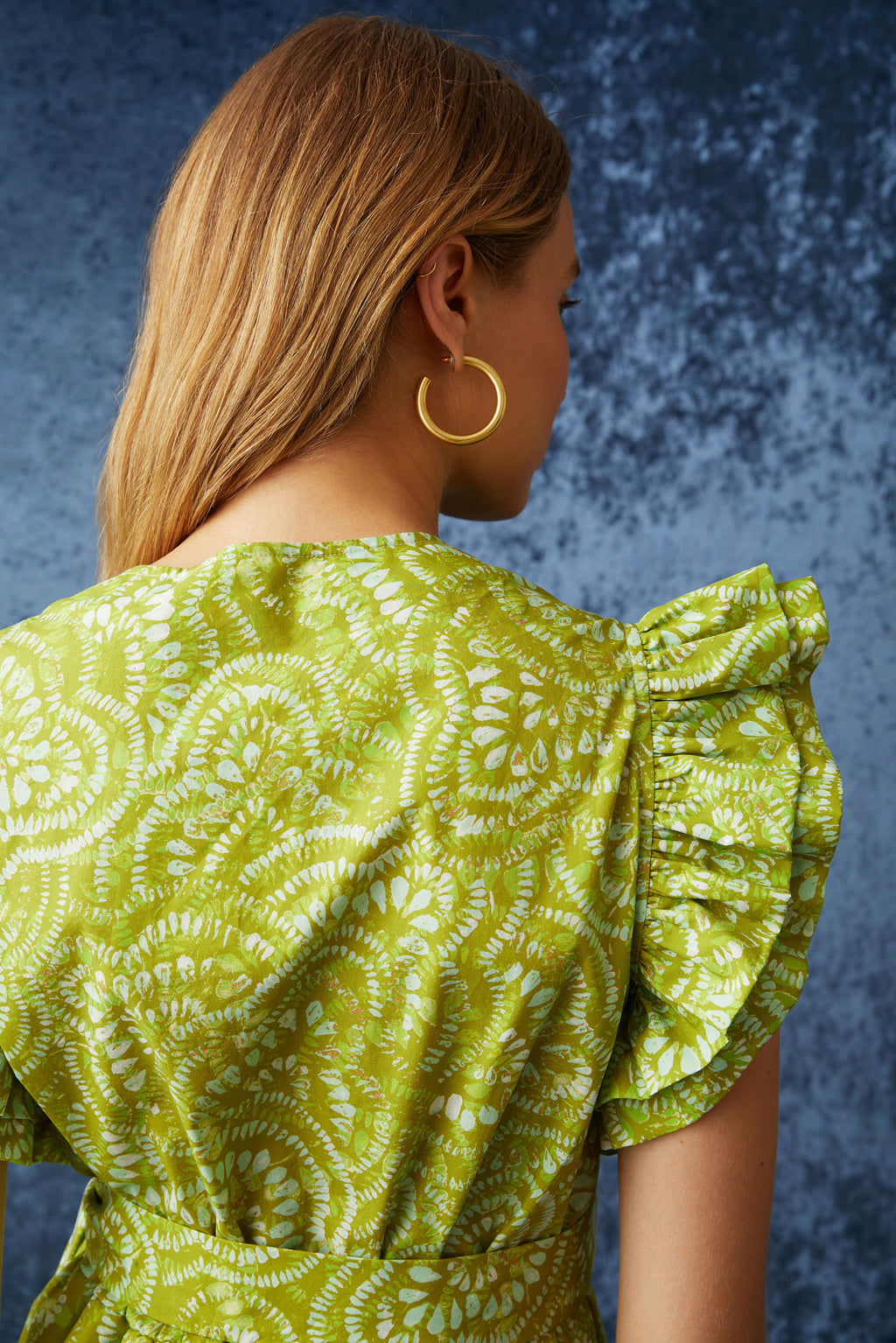 Short dress with large ruffled sleeves and v-neckline in a bright lime green floral print