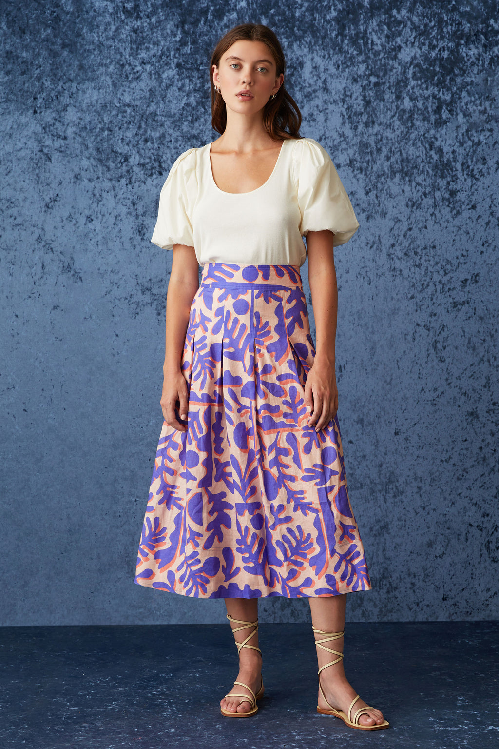 Geometric printed maxi skirt that sits at the high waistline with a side zip closure in a pink and purple color