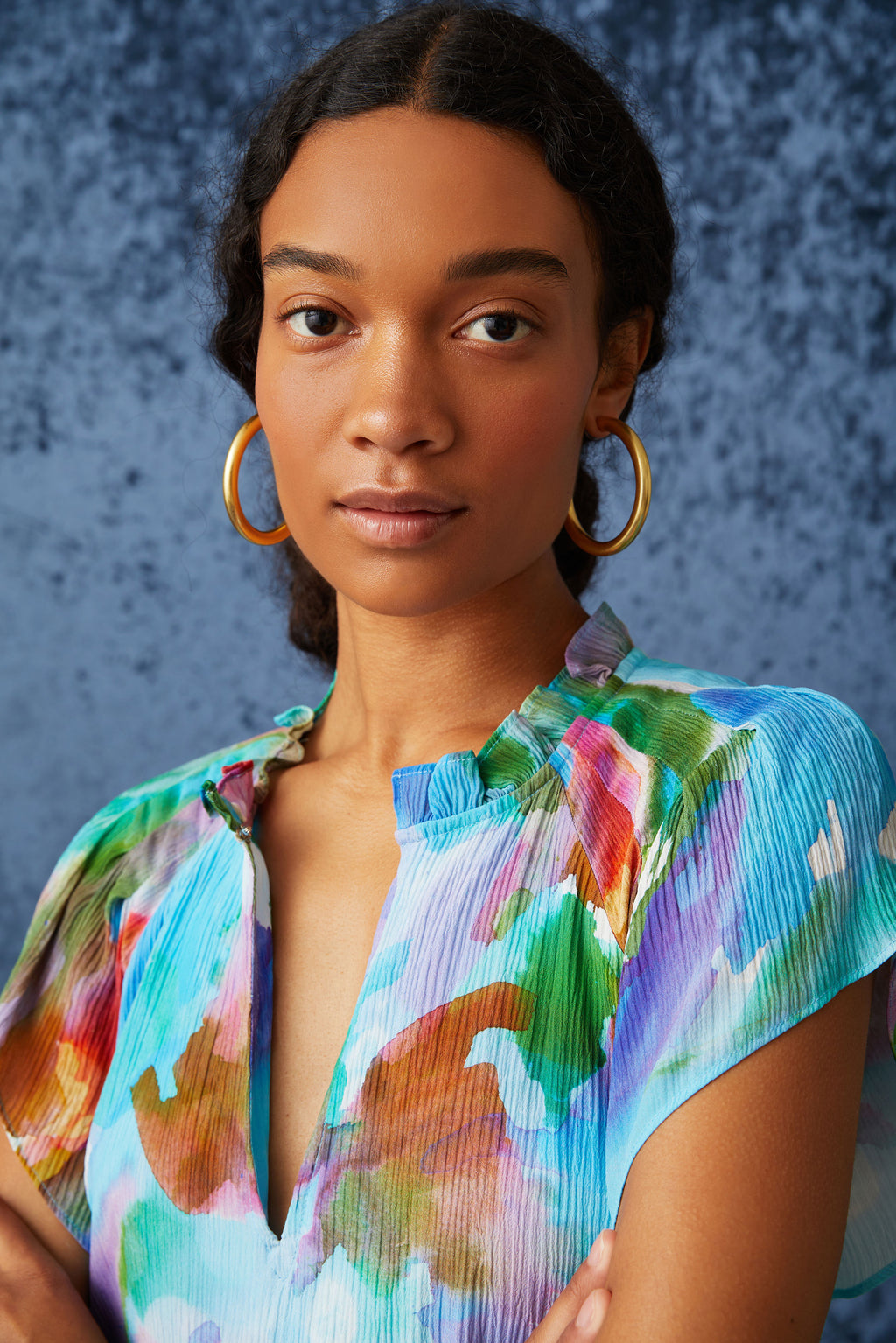 Blue watercolor mini dress with short flutter sleeves and an adjustable front clasp neckline 