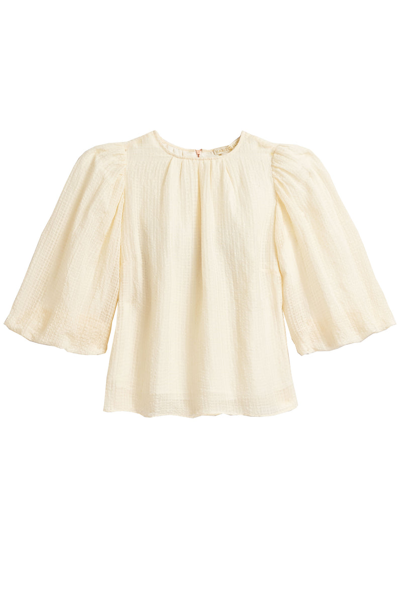 full sleeve top in an off-white fabric with an exposed rose gold zipper in the back