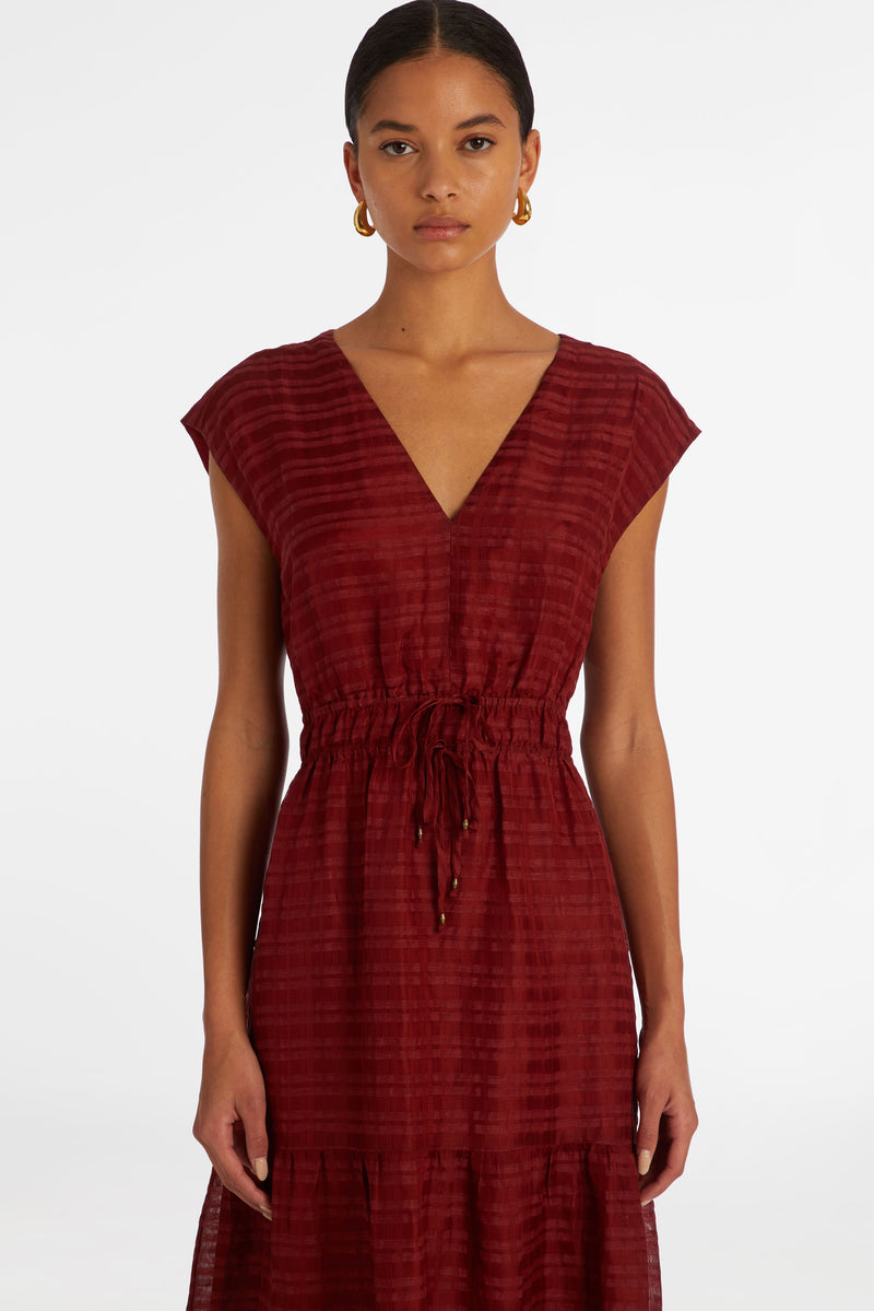 Long dress that has short cap sleeves and an adjustable cinched waist