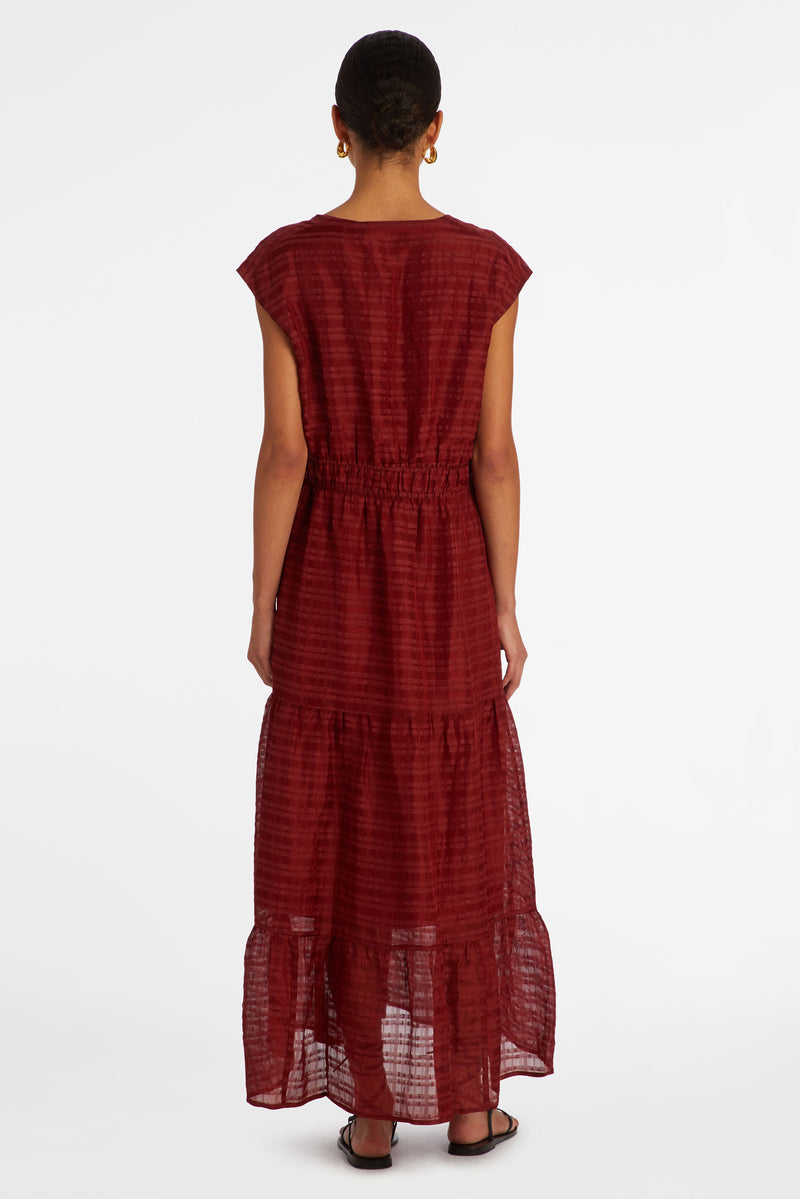 Dark red maxi dress with a v-neckline and a thick waistband that can be adjusted using a tie
