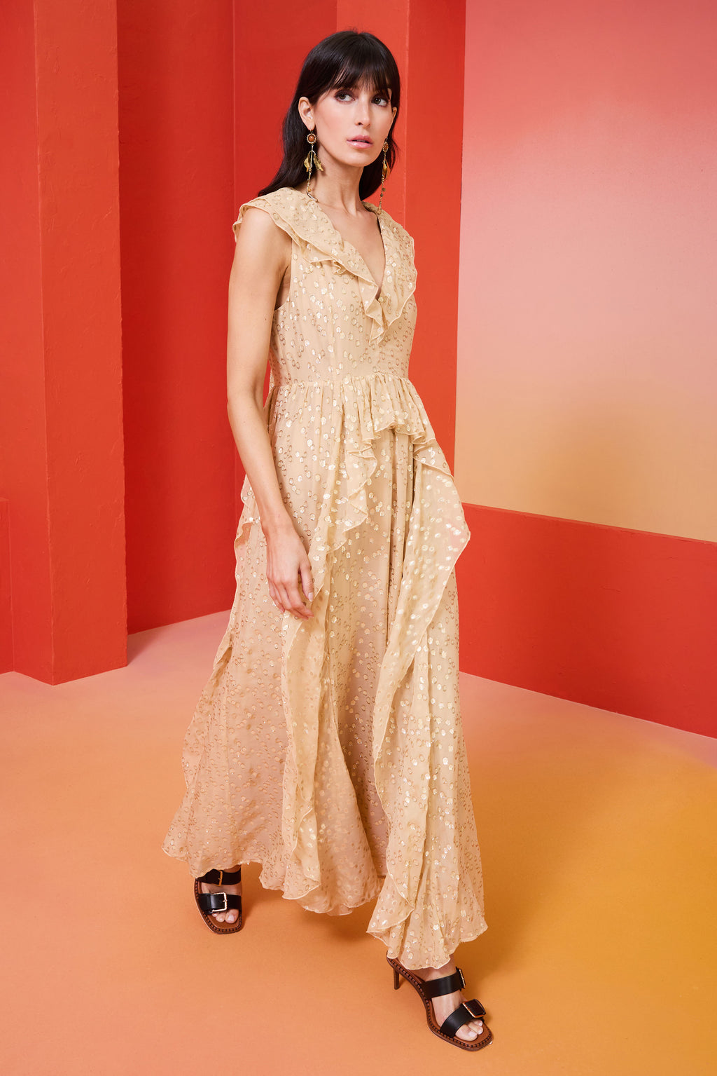 cream long dress with gold flecks and a ruffle v-neck in the front and back and a tie closure at the back of the neck