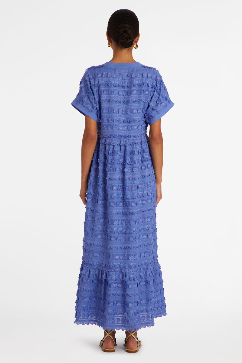 Long dress in a solid light blue color with a rounded fringe pattern 
