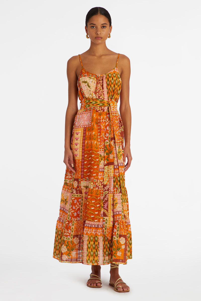 Maxi dress in a floral patchwork print that has a slip on silhouette and an adjustable sash tie waist 