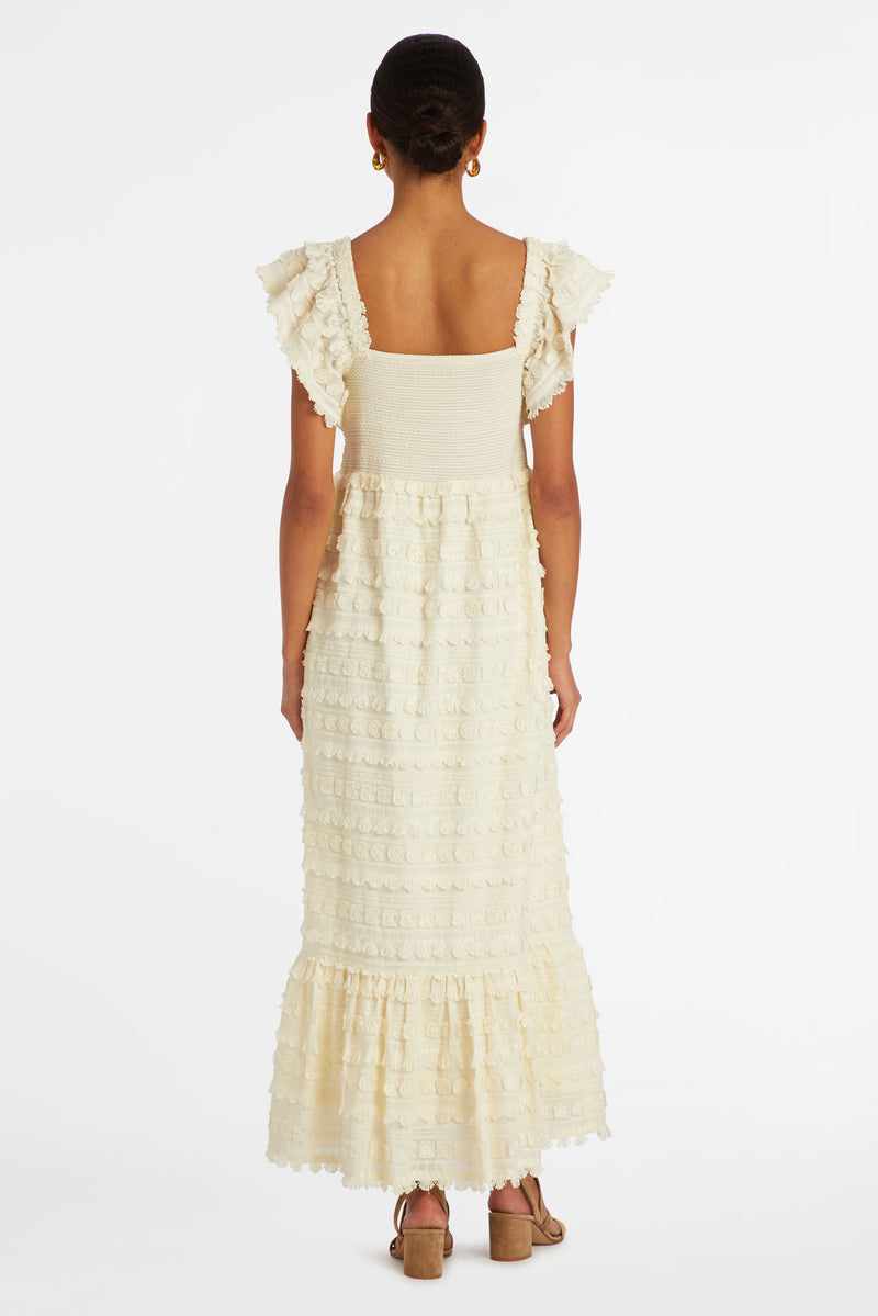 Long dress that has a smocked bodice and is cinched in at the waist