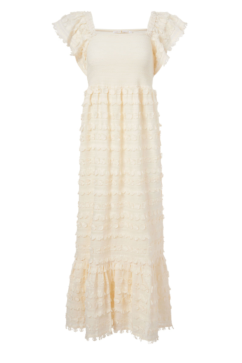 Solid white maxi dress that has a circular tassel pattern 