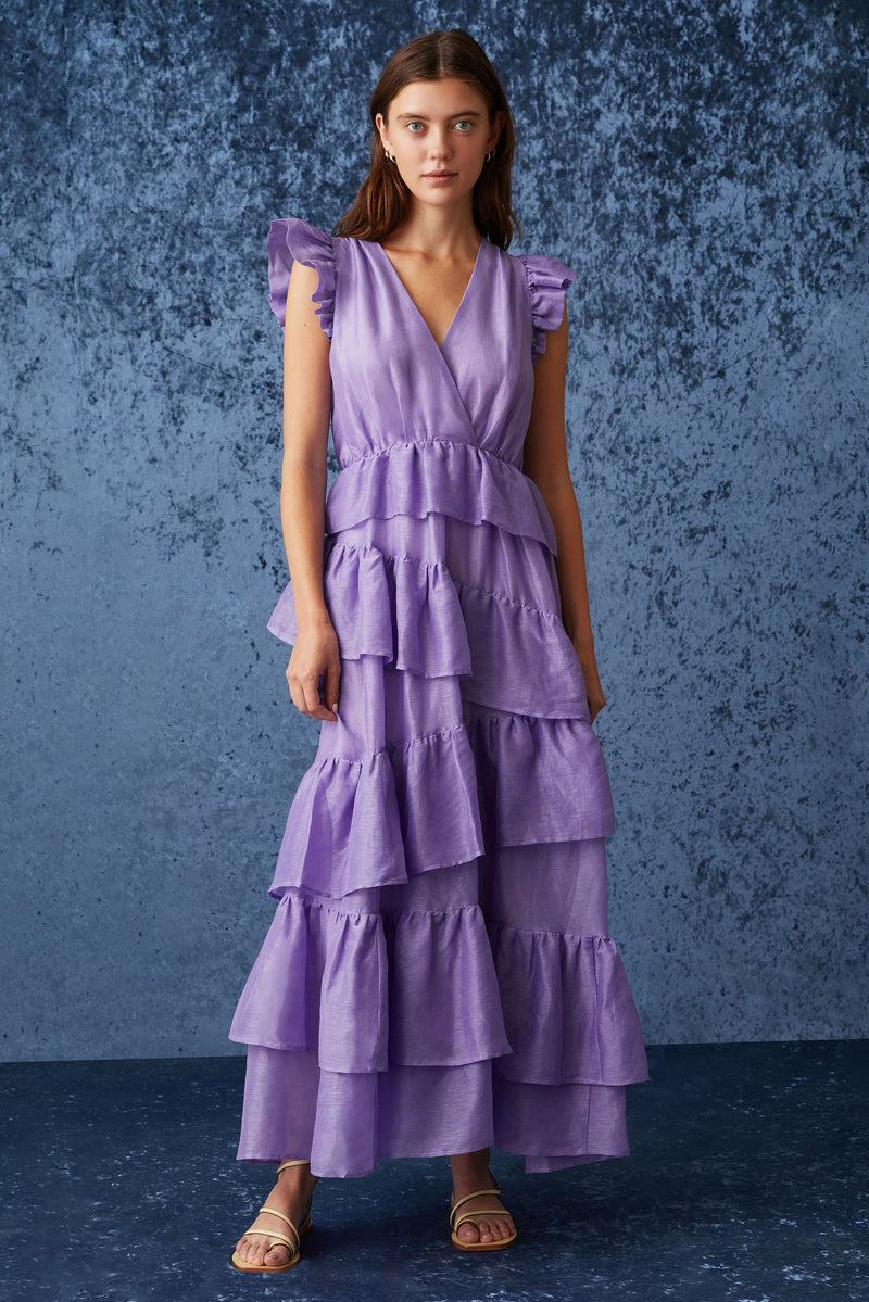 Sleeveless maxi dress with ruffled shoulder that is cinched at the waist and has asymmetrical tiered ruffles