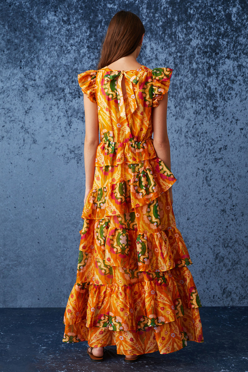 Dark blue floral maxi dress that is cinched at the waist with an asymmetrical ruffled tiered skirt 