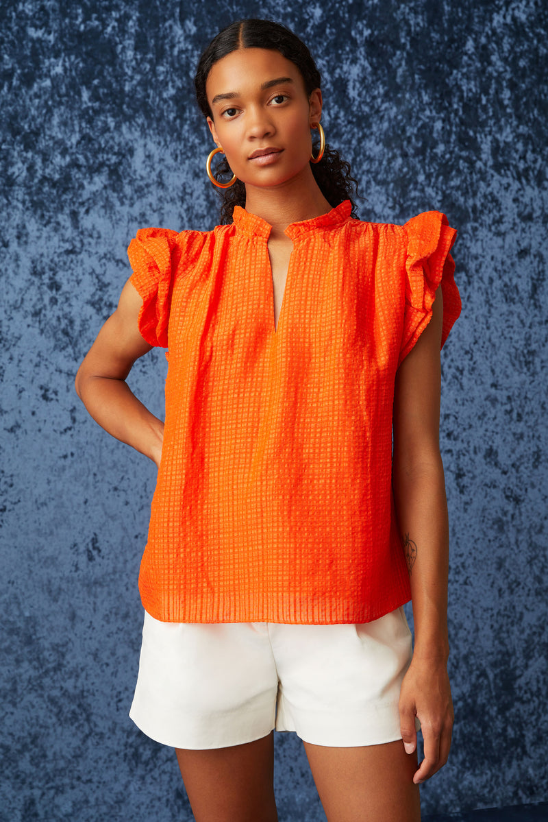 Clasp neckline blouse with ruffle detailing along the neckline and short sleeves\