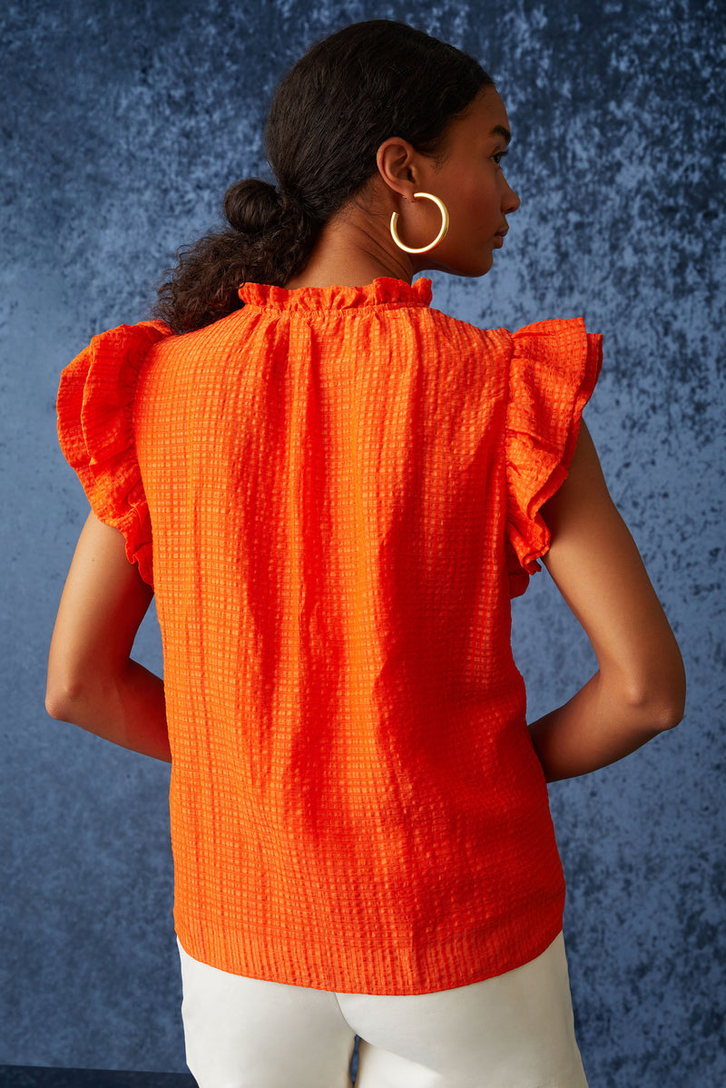 Clasp neckline blouse with ruffle detailing along the neckline and short sleeves\