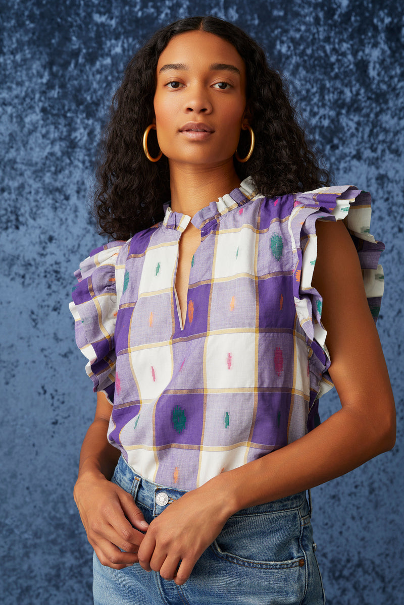 Top with a ruffle neckline and sleeves with an adjustable neckline in a purple metallic stripe 