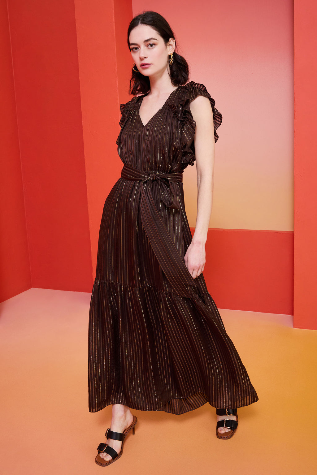long dress in a brown color with gold flecks with ruffled short sleeves