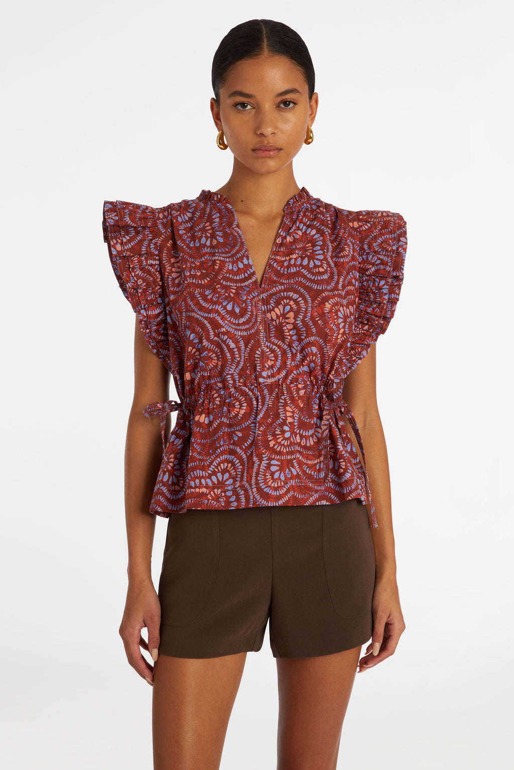 Short sleeve peplum top that is cinched at the waist in a dark pink checkered print