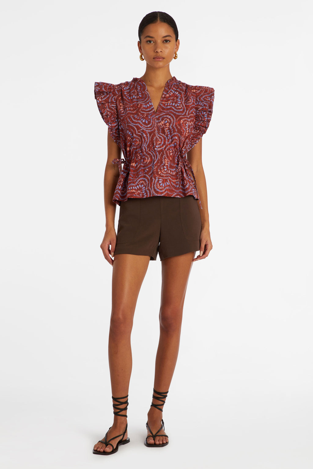 Dark pink checkered print top that has adjustable ties at each side of the waist to cinch in the waist