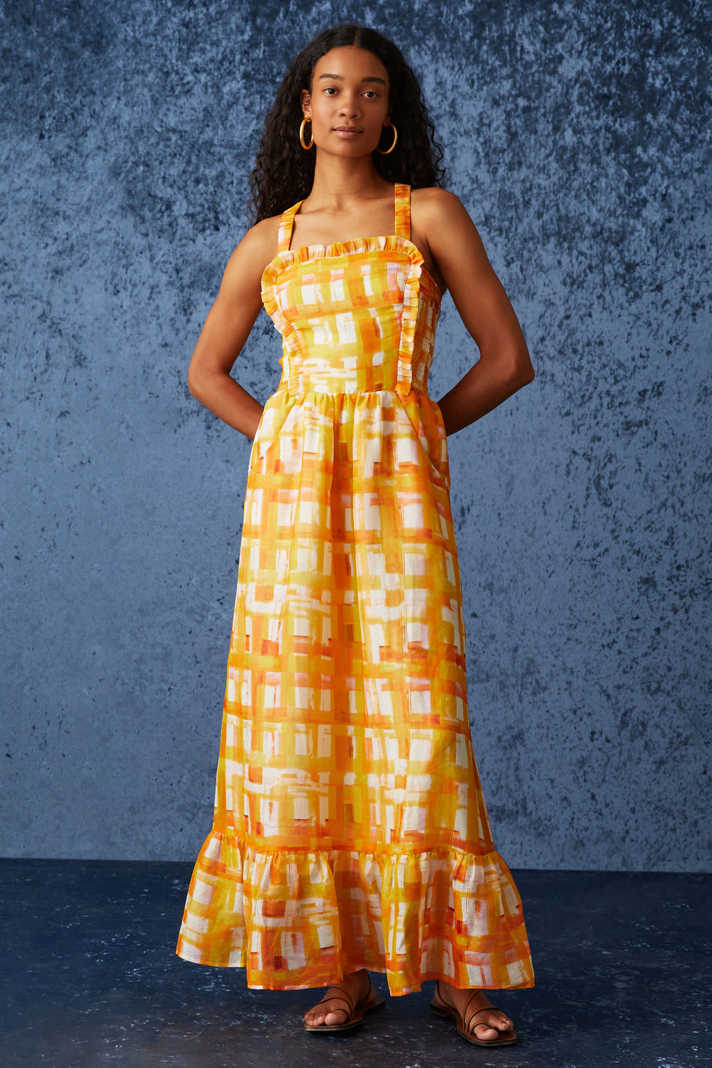 Midi dress that is cinched at the waist with straps that cross over in the back and square neckline