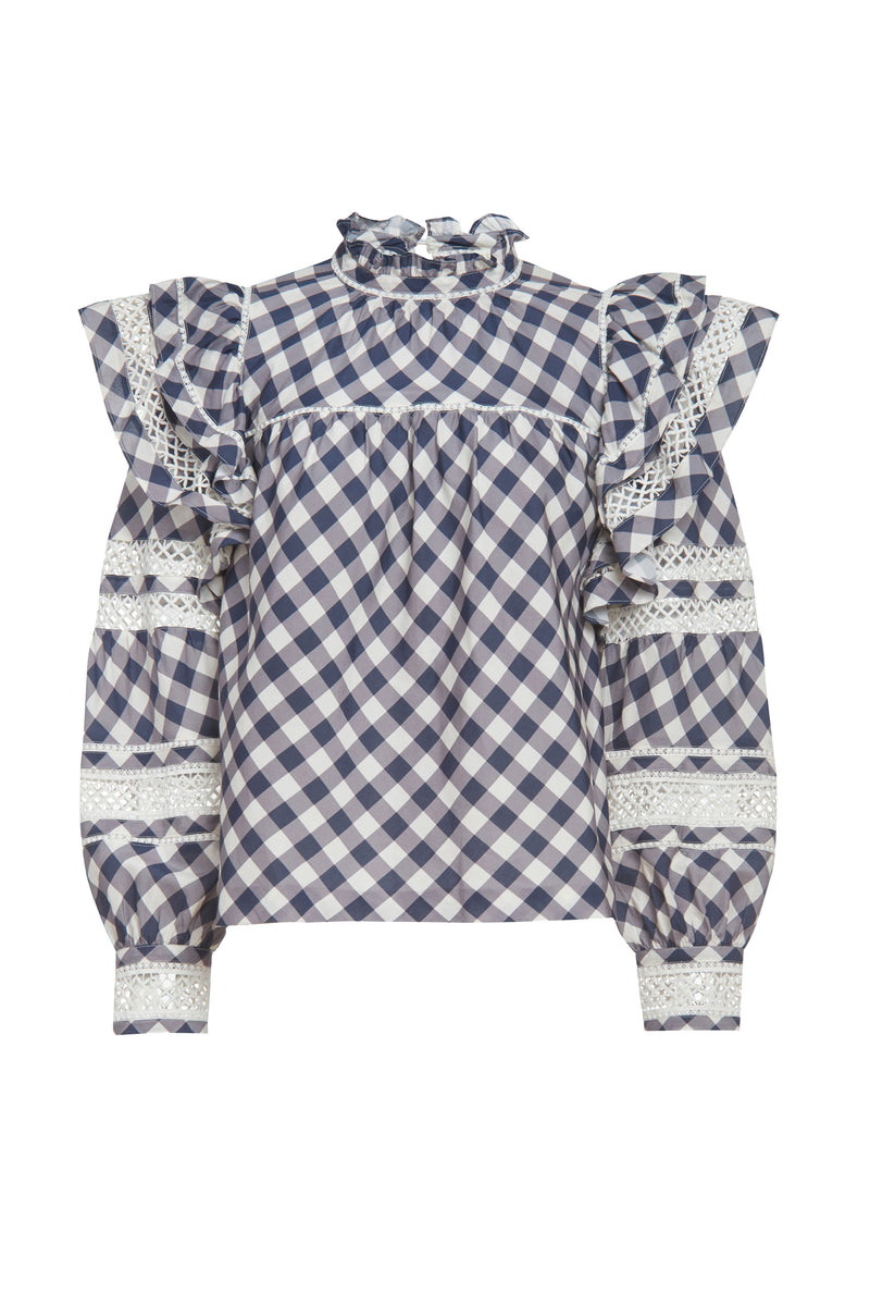 Navy and white plaid long sleeve top with cuffed sleeves and a ruffle detail on the shoulder above the sleeve