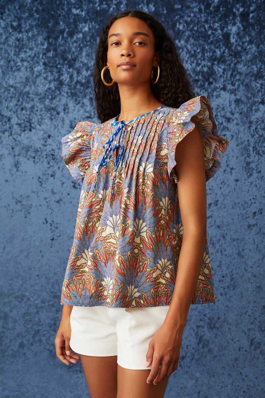 Blue and red floral top with pleated chest plate and ruffled sleeves
