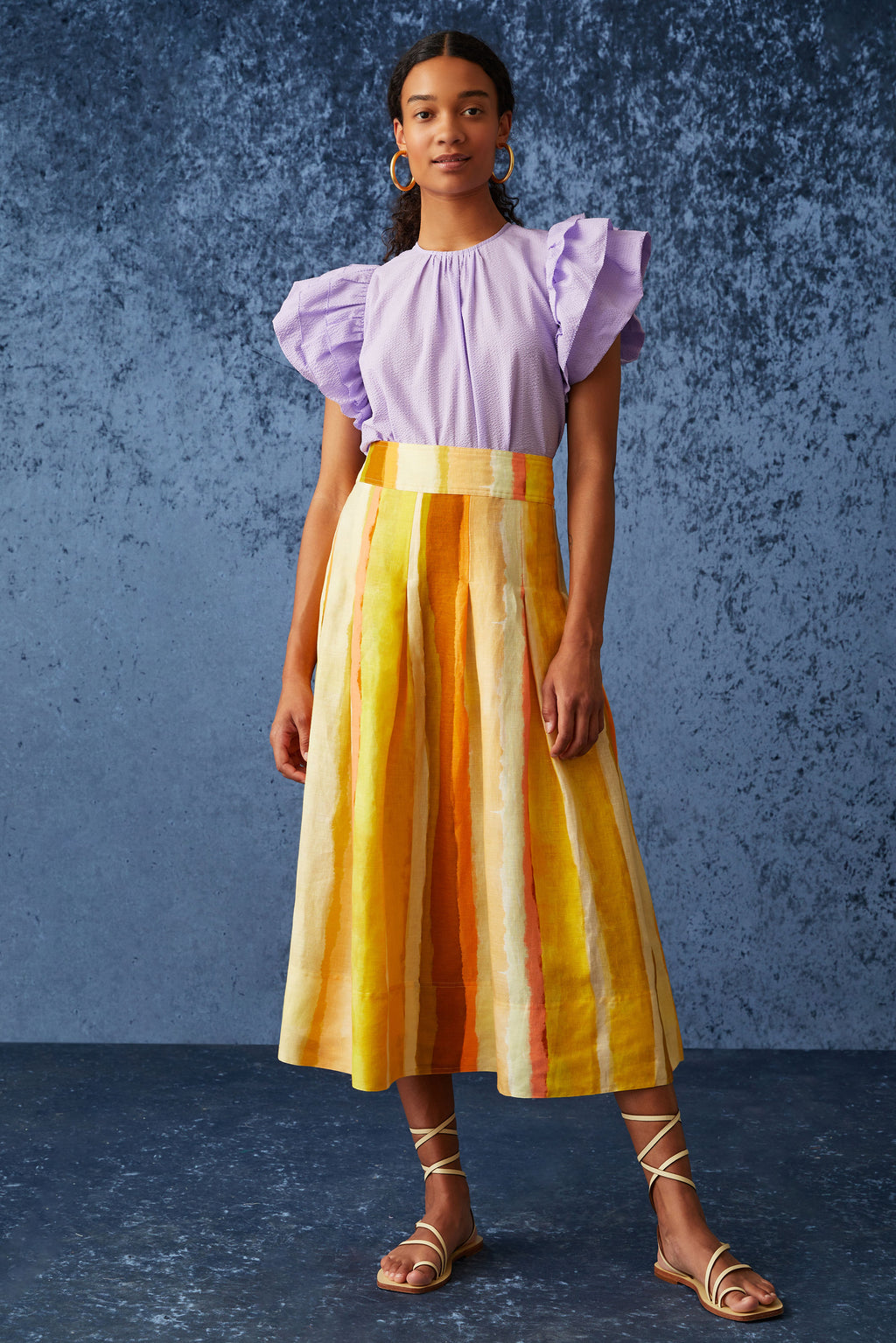 Light purple top with large flutter sleeves and a straight silhouette 