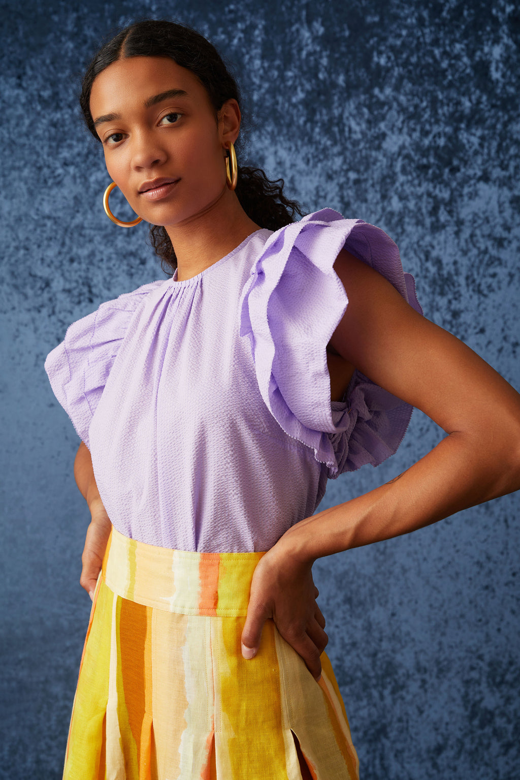Top with a simple slip on silhouette in a light purple solid color 