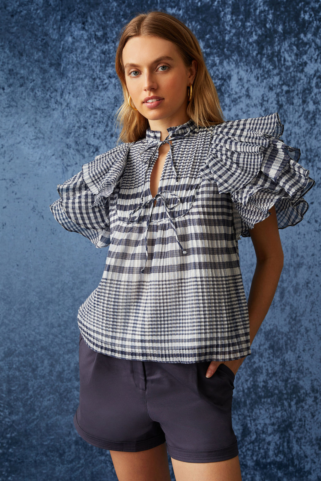 Short sleeve top with large flutter sleeves in a blue and white gingham