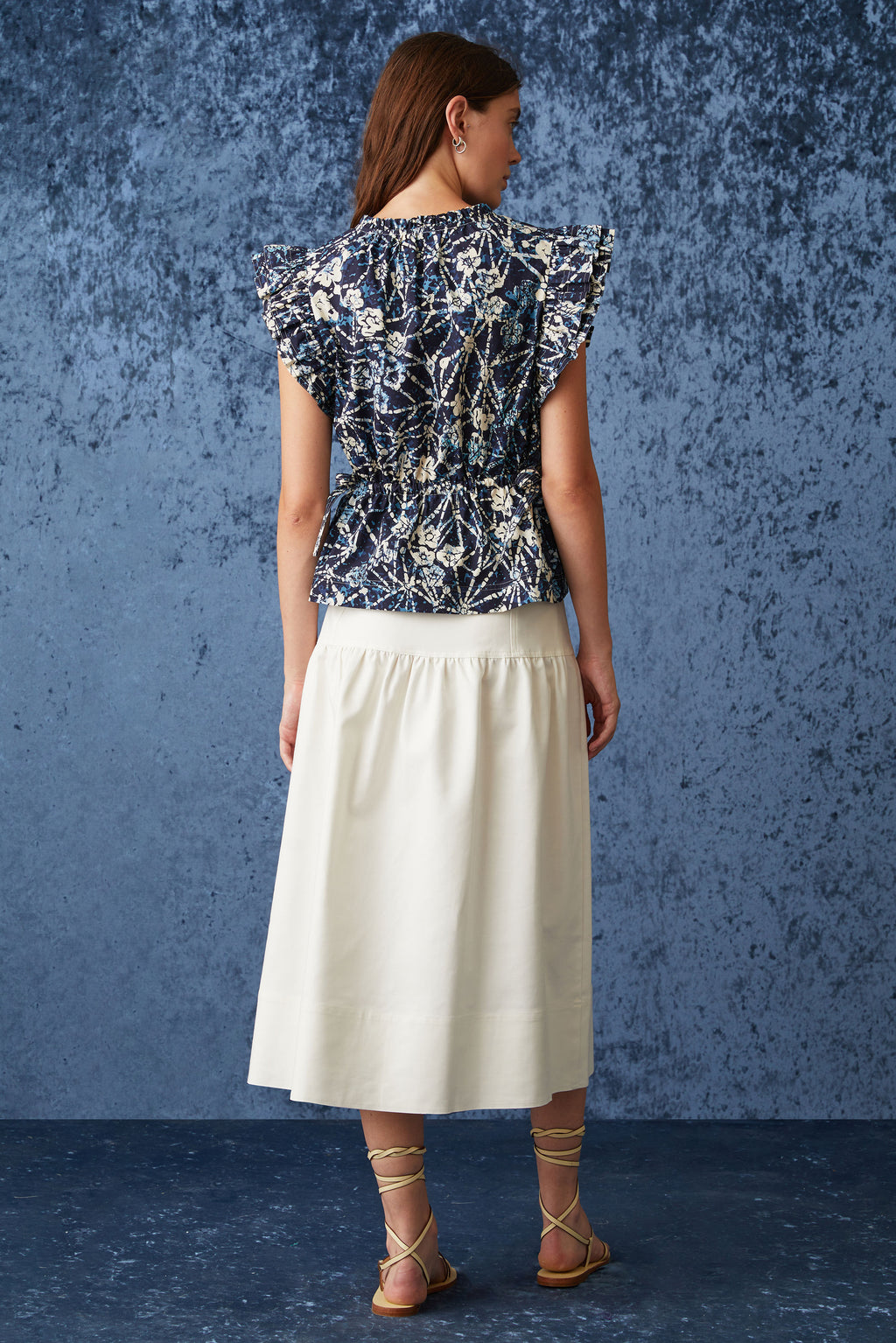 Solid white skirt with optional tie belt at the waist and straight silhouette