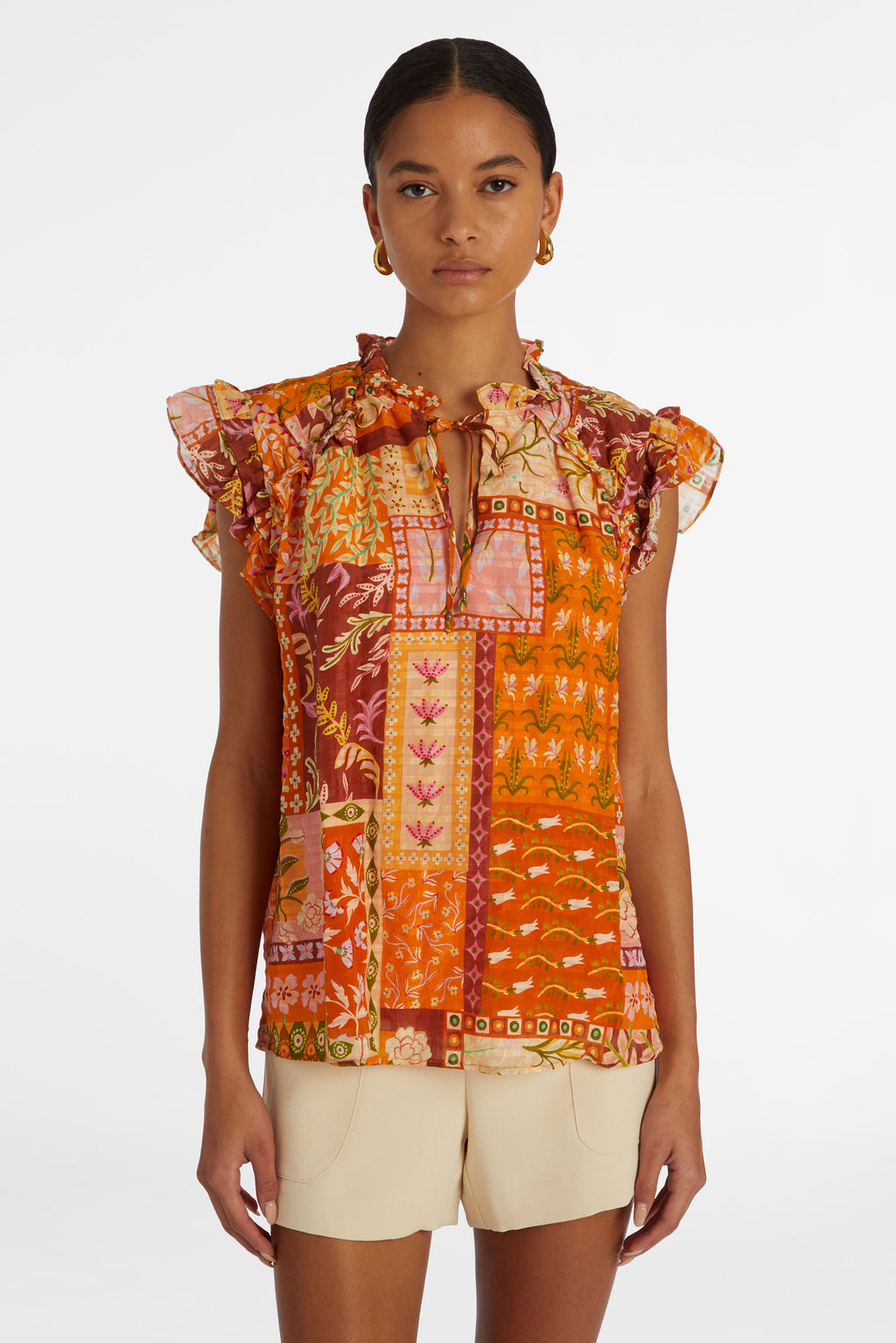 Short sleeve top with a straight silhouette in a orange floral patchwork print