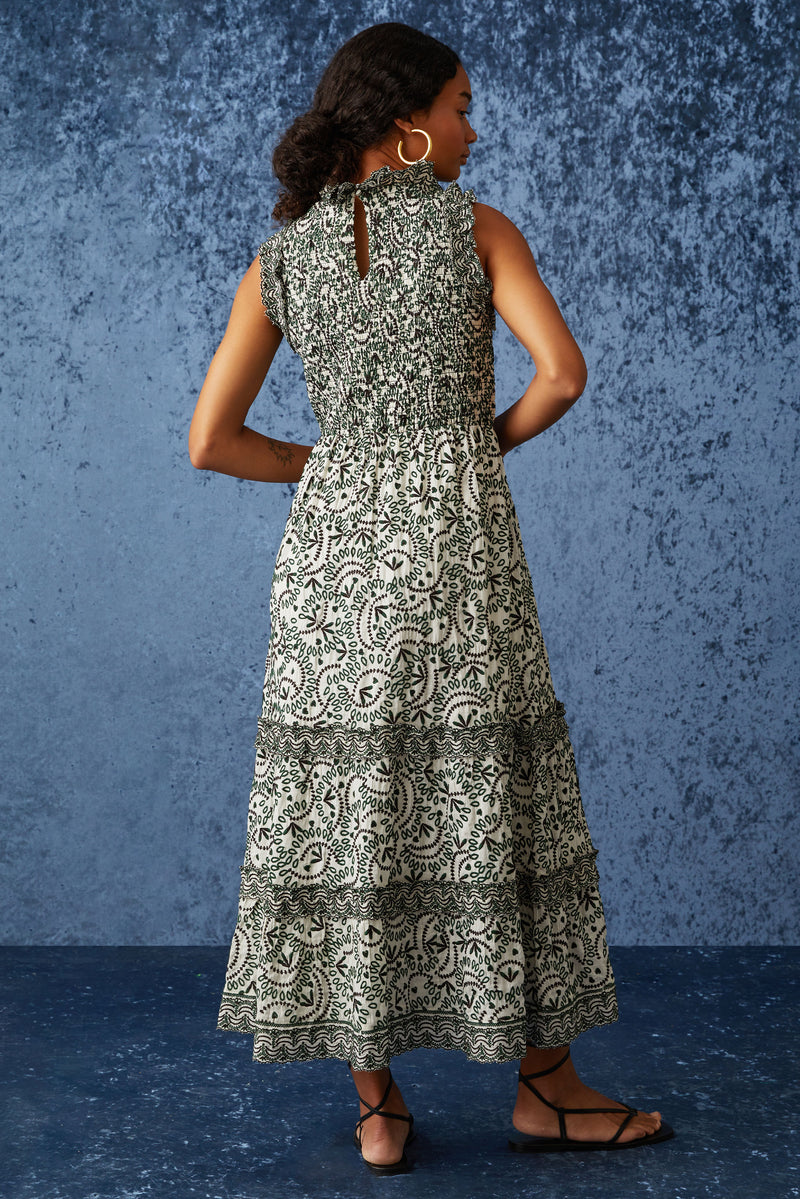 Sleeveless dress with high neckline in a green and white embroidery 