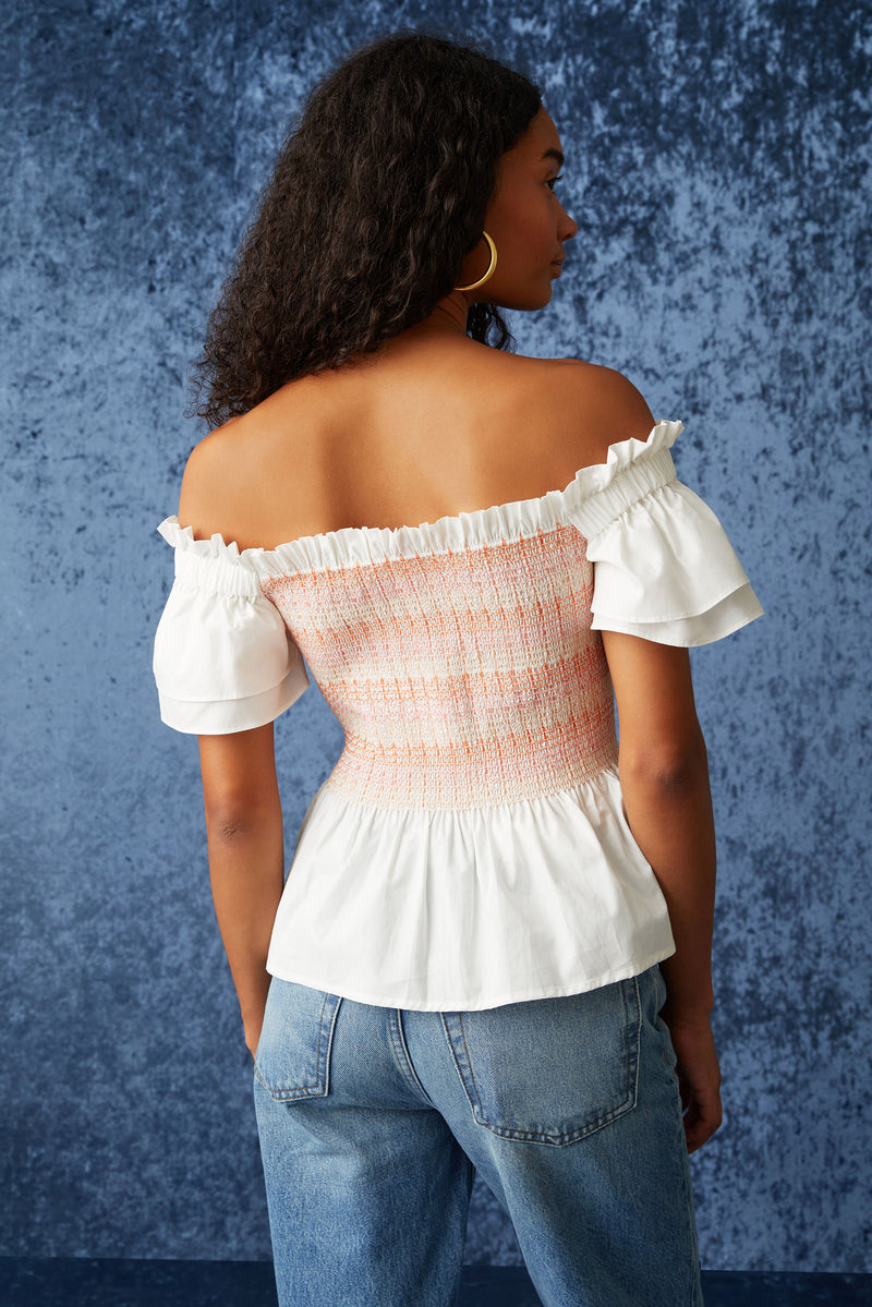 Pink and white smocked square neck top with sleeves that cnan be wore on or off the shoulder